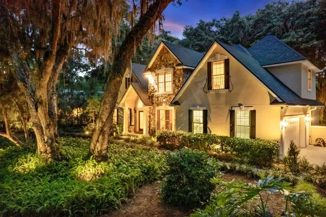 a view of a brick house with potted plants