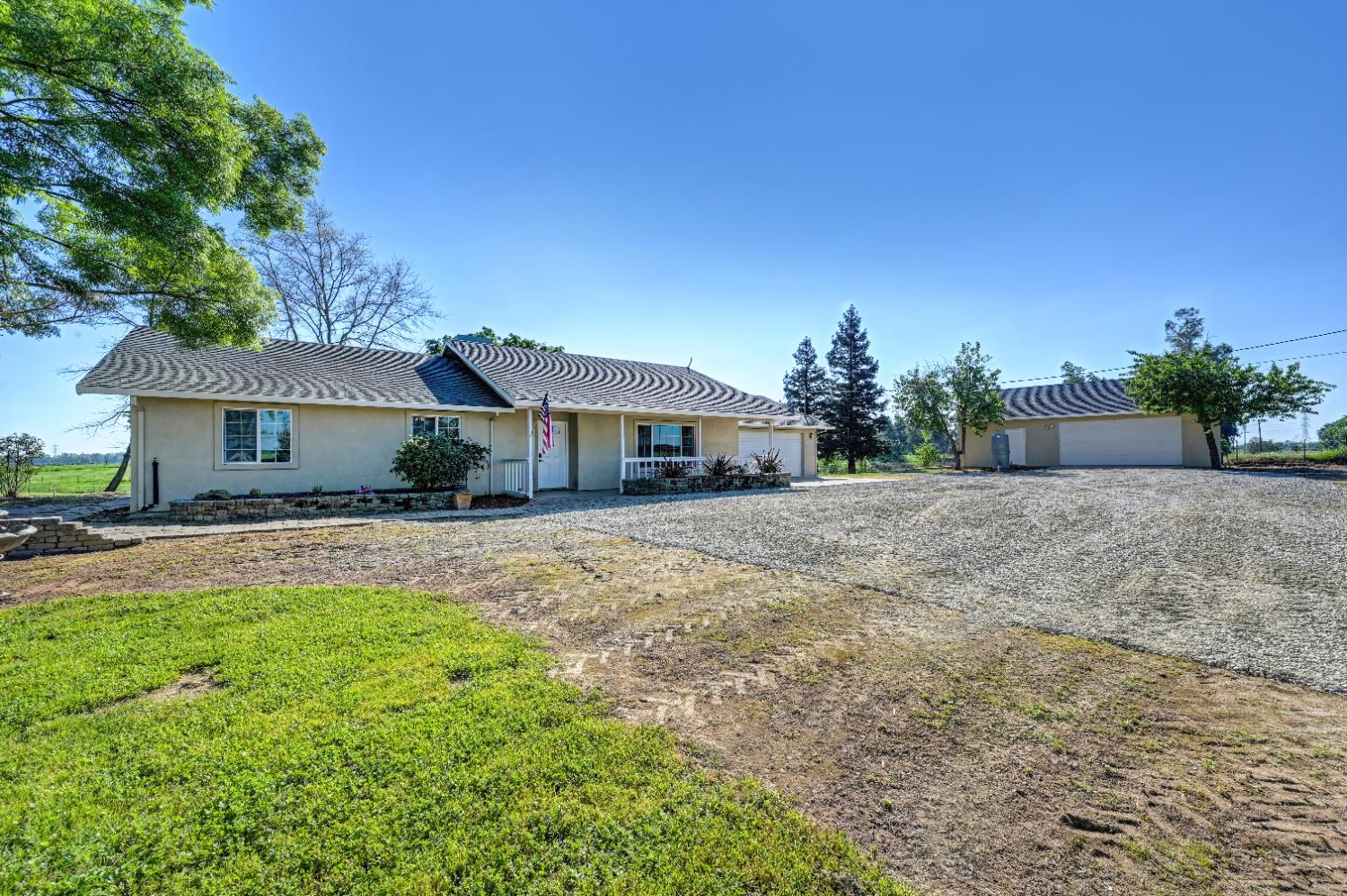 12260 Angle Road Herald, CA 95638 - Photo 42 of 43 a front view of a house with a yard and a garage