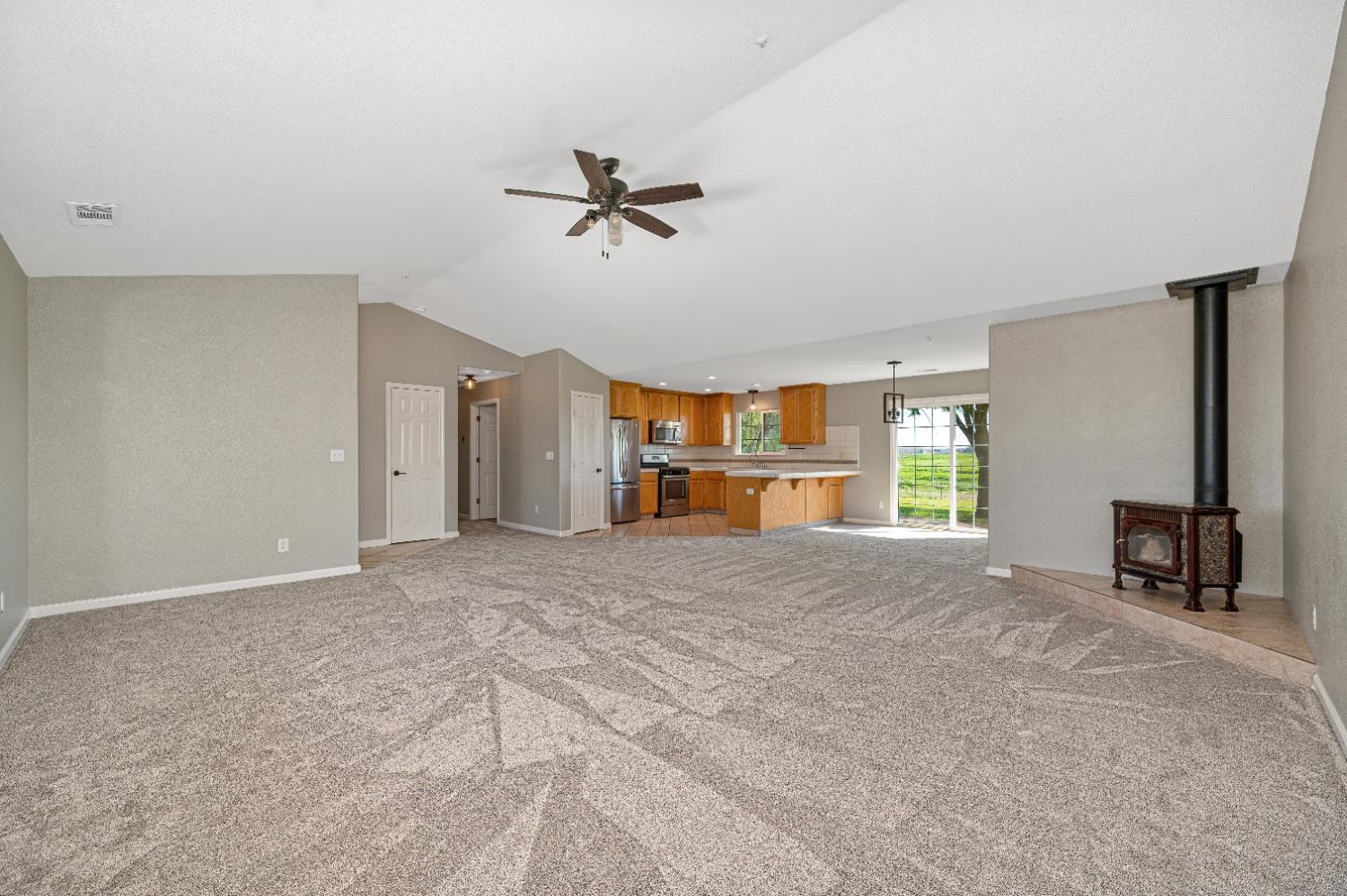 12260 Angle Road Herald, CA 95638 - Photo 5 of 43 a view of empty room with a fireplace and windows