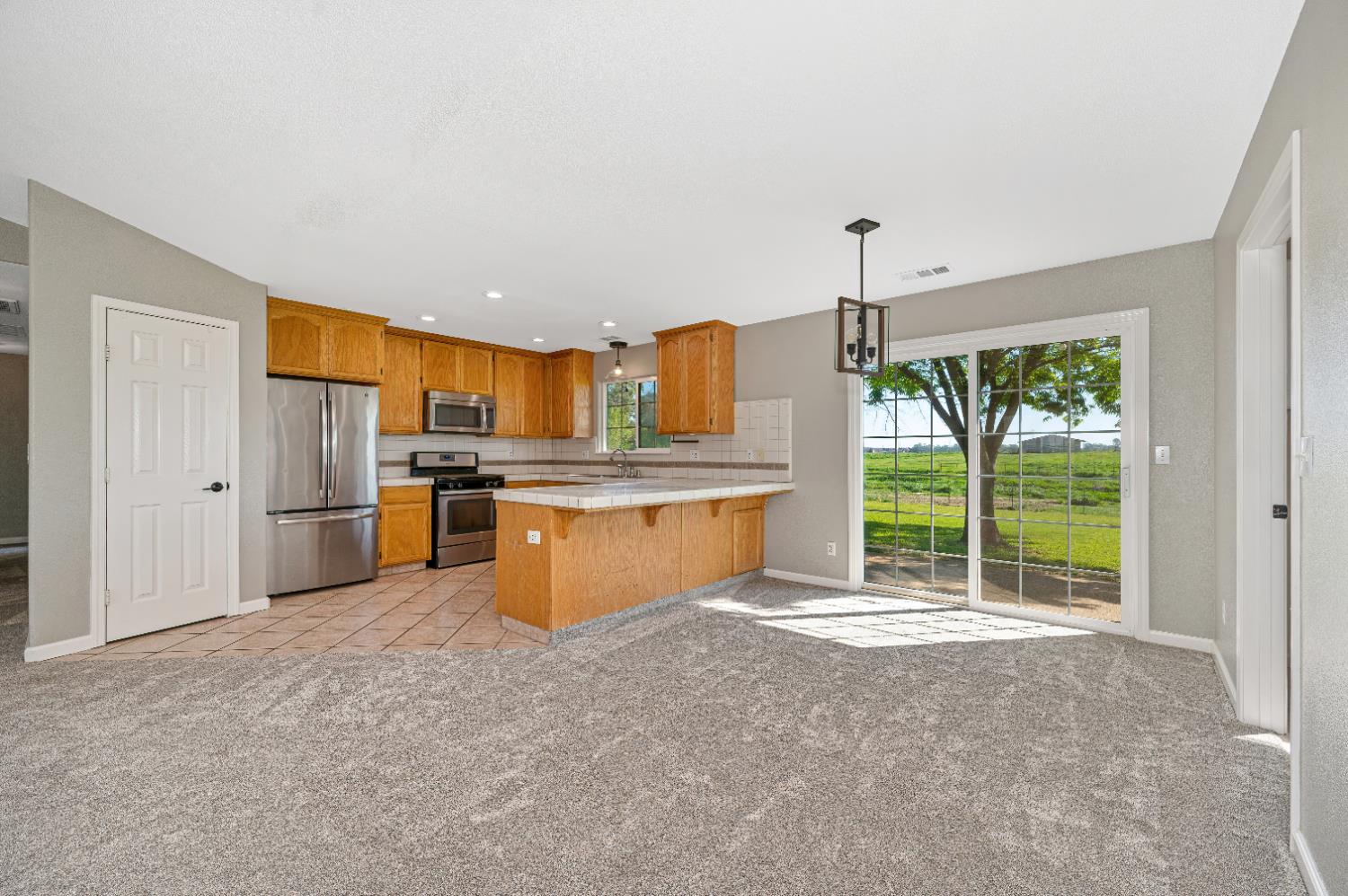 12260 Angle Road Herald, CA 95638 - Photo 7 of 43 a kitchen with stainless steel appliances granite countertop a stove a sink and a refrigerator