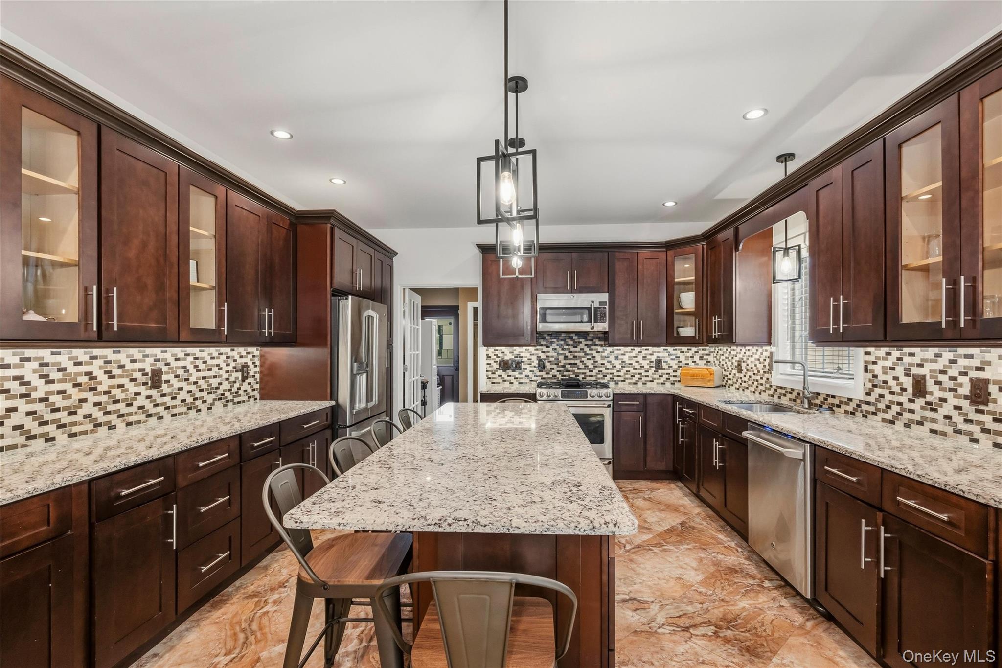 8 Darmstadter Road Bloomingburg, NY 12721 - Photo 21 of 47 Kitchen with 7 foot 7 inch center island that seats 6, Anderson casement window above sink, Cafe appliances, granite countertops, tile backsplash, uplighting, Recessed lighting, marble tile floors and 9 foot ceilings.