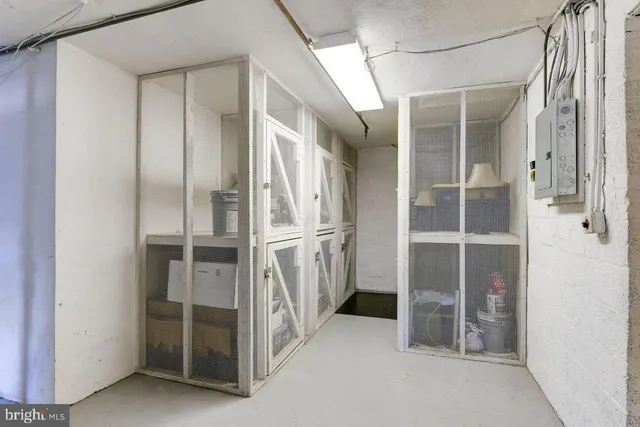 a view of a storage and utility room with washer and