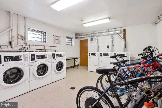 a city street lined with parked cars and buildings