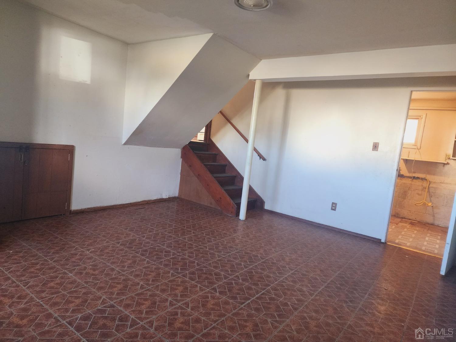 8 Eastlick Road Edison, NJ 08817 - Photo 6 of 15 an empty room with staircase and white walls