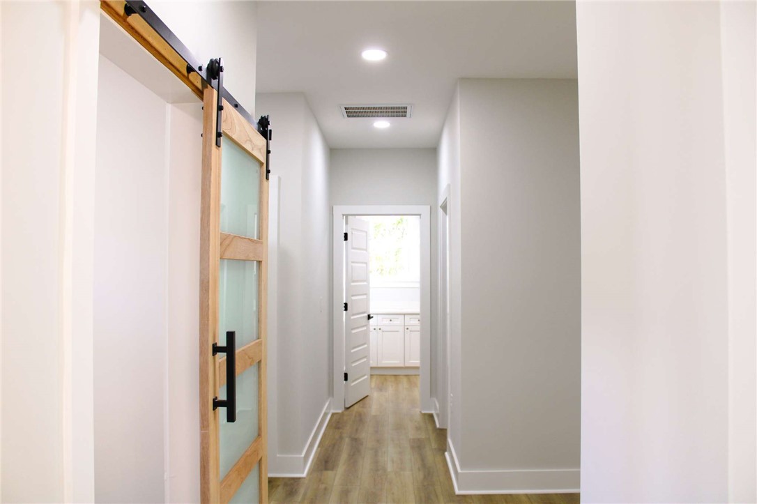 2515 Highway 29 Anderson, SC 29621 - Photo 15 of 38 A well-lit hallway with modern barn door entry to a bright interior space.