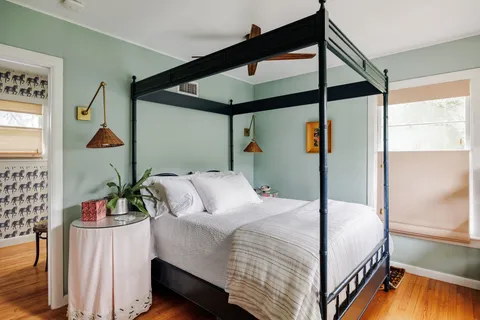 a bedroom with double bed and a window