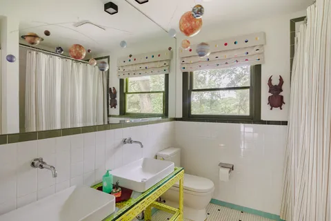 a bathroom with a sink a toilet and shower curtain