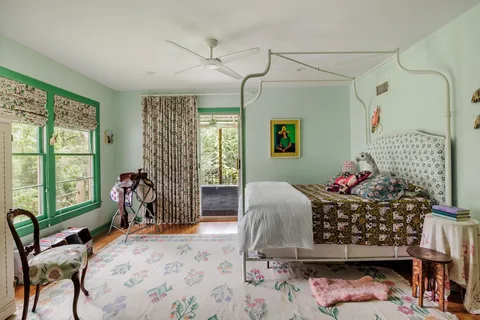 a bed room with a bed and a chair