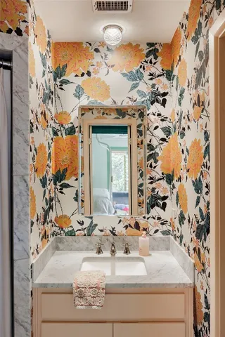 a bathroom with a sink toilet and shower curtain