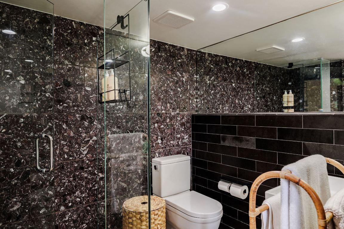 4201 Gregg Ward Lane Austin, TX 78744 - Photo 23 of 40 a bathroom with a toilet and shower