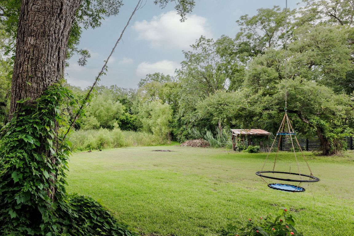 4201 Gregg Ward Lane Austin, TX 78744 - Photo 26 of 40 a backyard of a house with chairs and wooden fence