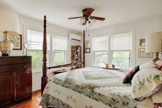 a living room with furniture fireplace and a large window