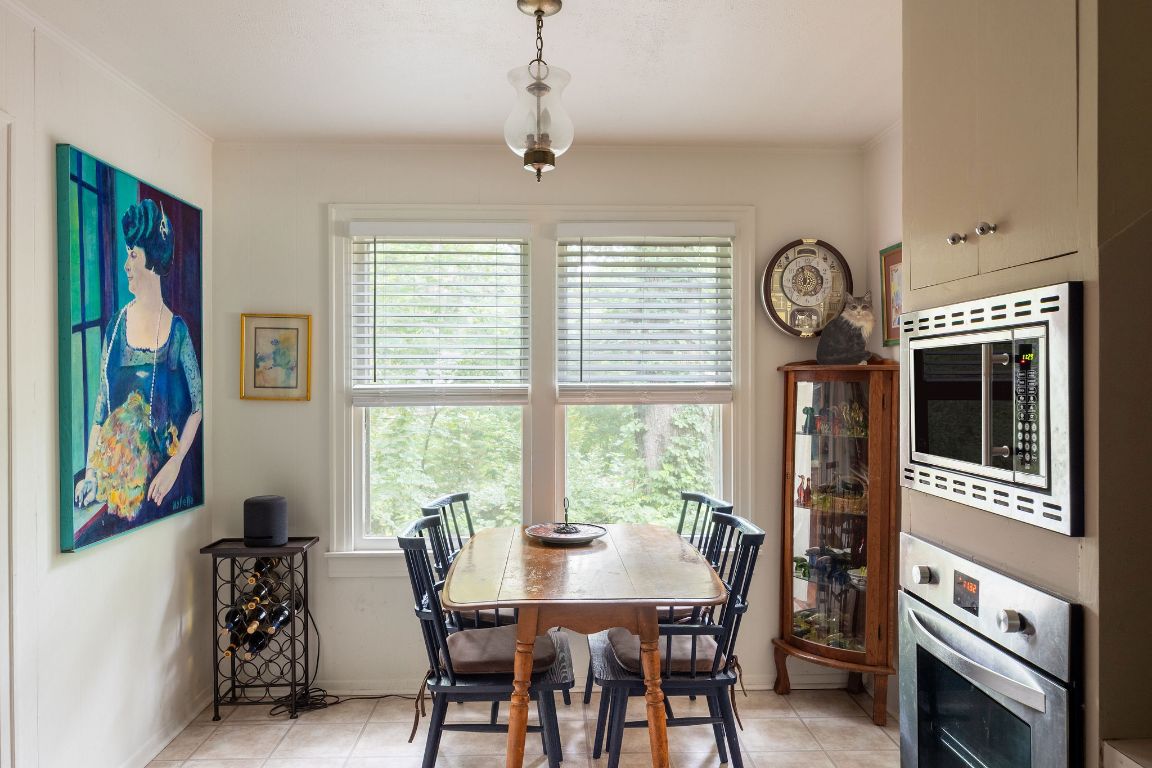 4201 Gregg Ward Lane Austin, TX 78744 - Photo 36 of 40 a view of a dining room with furniture window and wooden floor