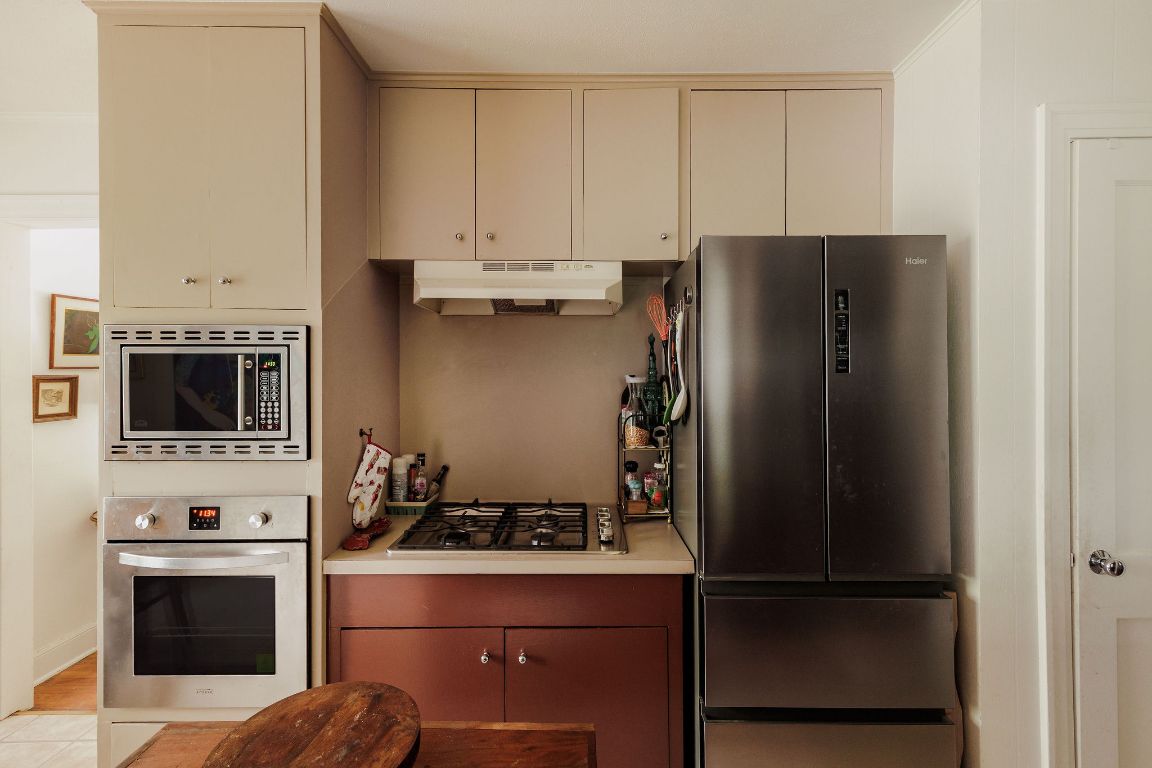 4201 Gregg Ward Lane Austin, TX 78744 - Photo 37 of 40 a kitchen with a refrigerator stove and microwave
