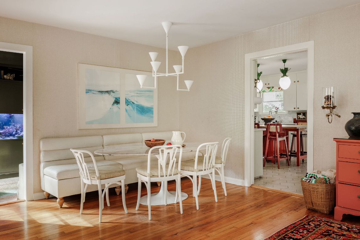4201 Gregg Ward Lane Austin, TX 78744 - Photo 4 of 40 a dining room with furniture wooden floor a rug and a chandelier