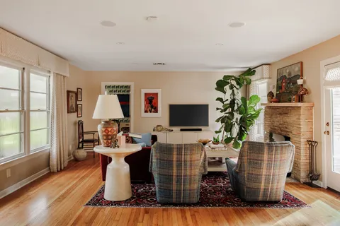a dining room with furniture a flat screen tv and a window
