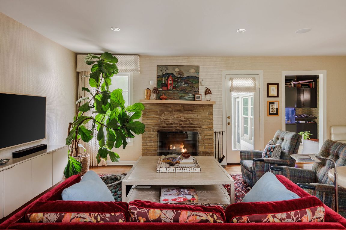 4201 Gregg Ward Lane Austin, TX 78744 - Photo 6 of 40 a living room with furniture a flat screen tv and a fireplace