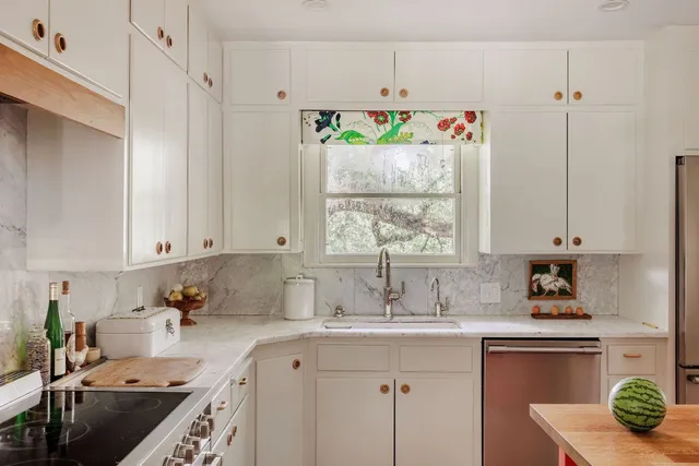 a kitchen with stainless steel appliances granite countertop a sink stove and cabinets