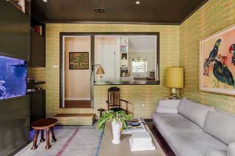 a living room with furniture and a potted plant