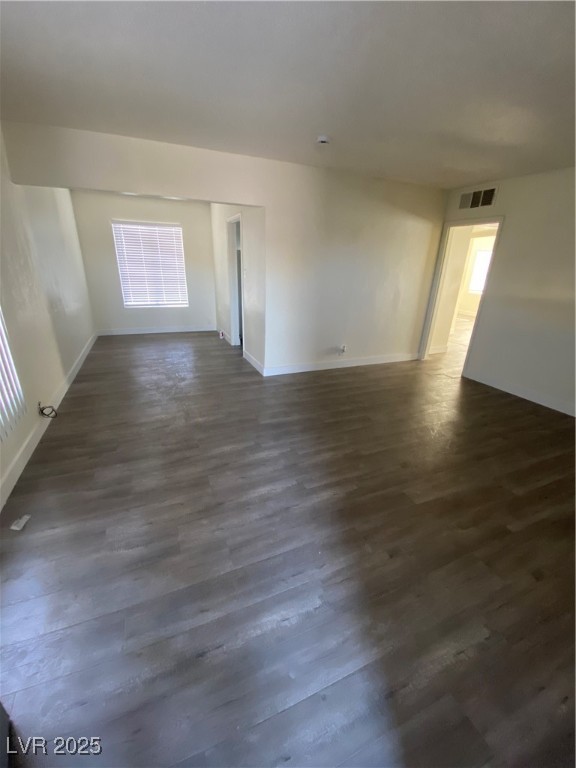 1711 Santa Paula Drive, Unit B Las Vegas, NV 89104 - Photo 4 of 17 Spare room with dark wood finished floors and healthy amount of natural light