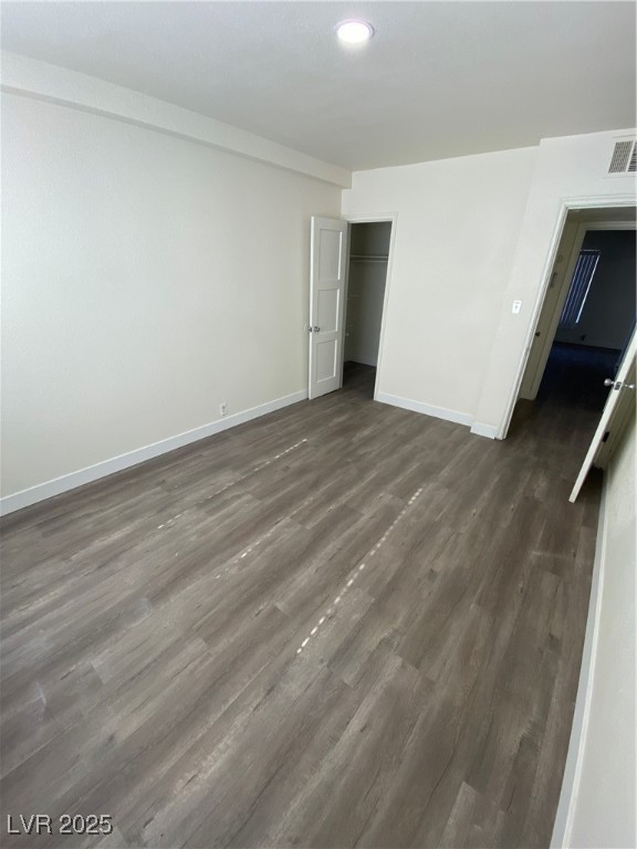 1711 Santa Paula Drive, Unit B Las Vegas, NV 89104 - Photo 10 of 17 Unfurnished bedroom featuring dark wood-style flooring, a closet, and recessed lighting