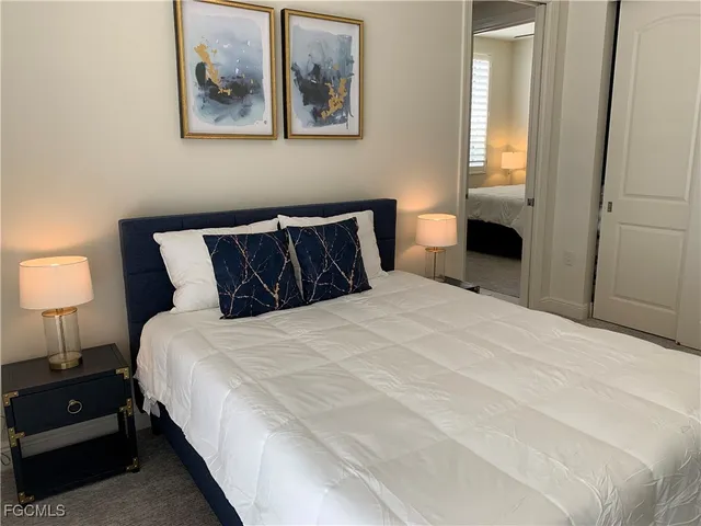 a bedroom with bed and wall painting with wooden floor