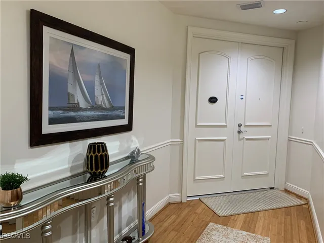 a view of a kitchen with a sink wooden floor and cabinets