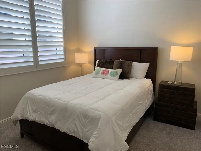 a bedroom with a bed and a night stand