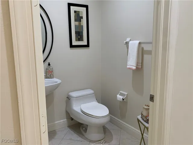 a white toilet sitting next to a bathroom sink