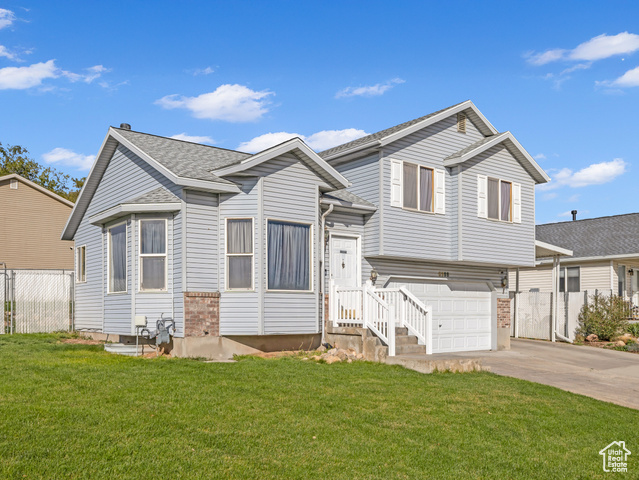 View of front of home featuring driveway and an attached garage