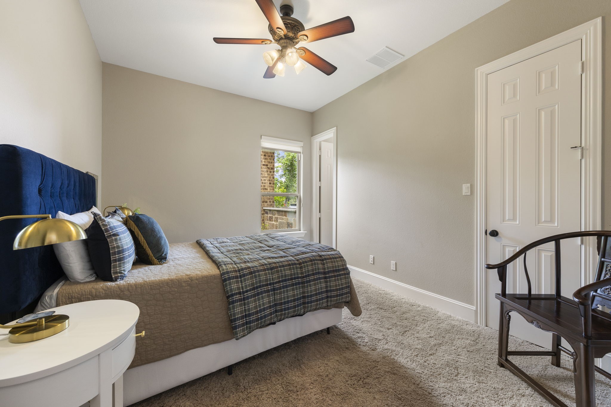 22 Marin Creek Place Spring, TX 77389 - Photo 19 of 38 First-floor guest suite with private bath and walk-in closet, offering comfort and privacy for visitors. Soft natural light and plush carpeting create a welcoming retreat.