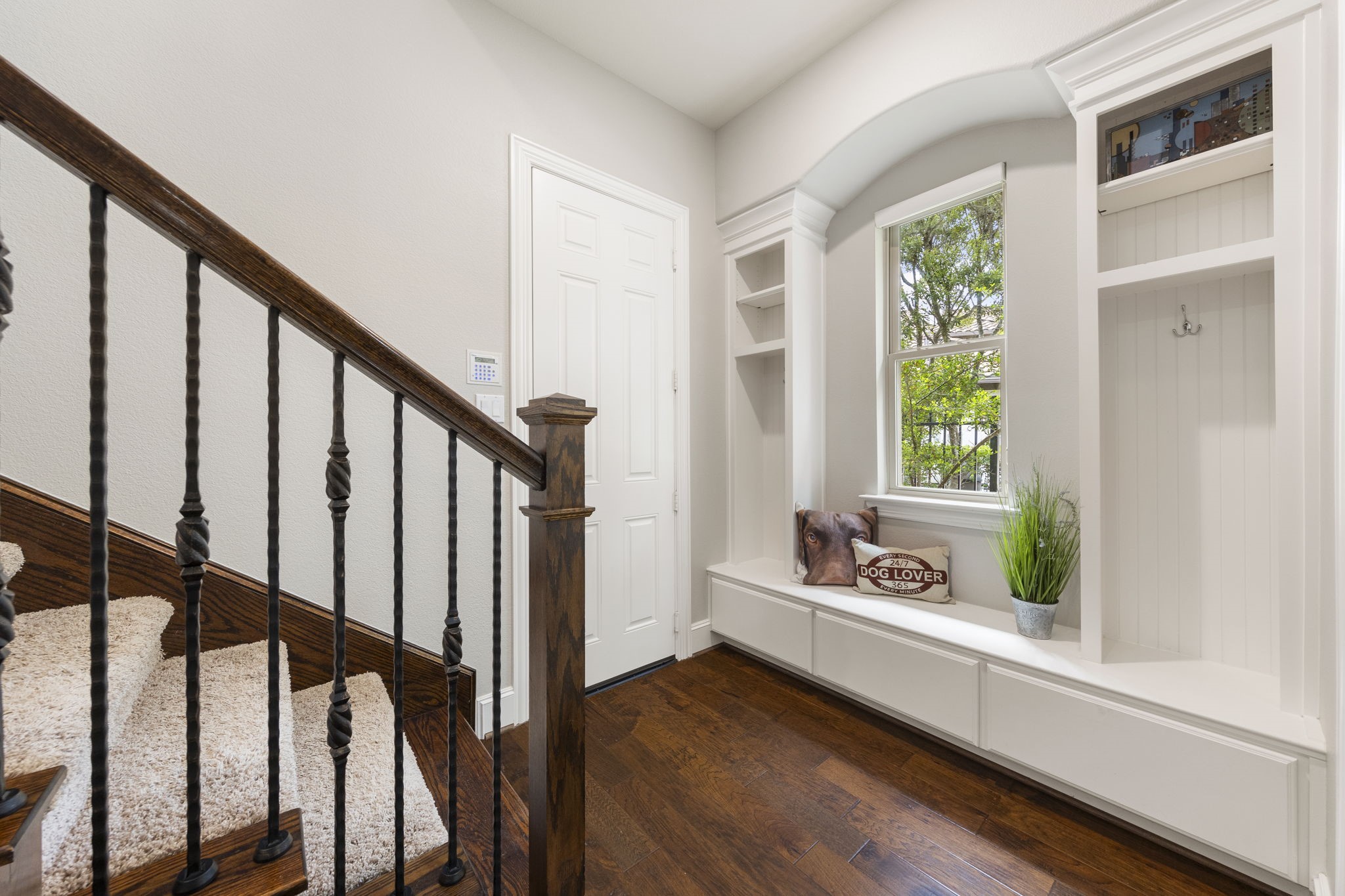 22 Marin Creek Place Spring, TX 77389 - Photo 20 of 38 Custom mudroom off the garage featuring built-in bench seating, storage cubbies, and hooks, conveniently connected to the utility room for everyday functionality.