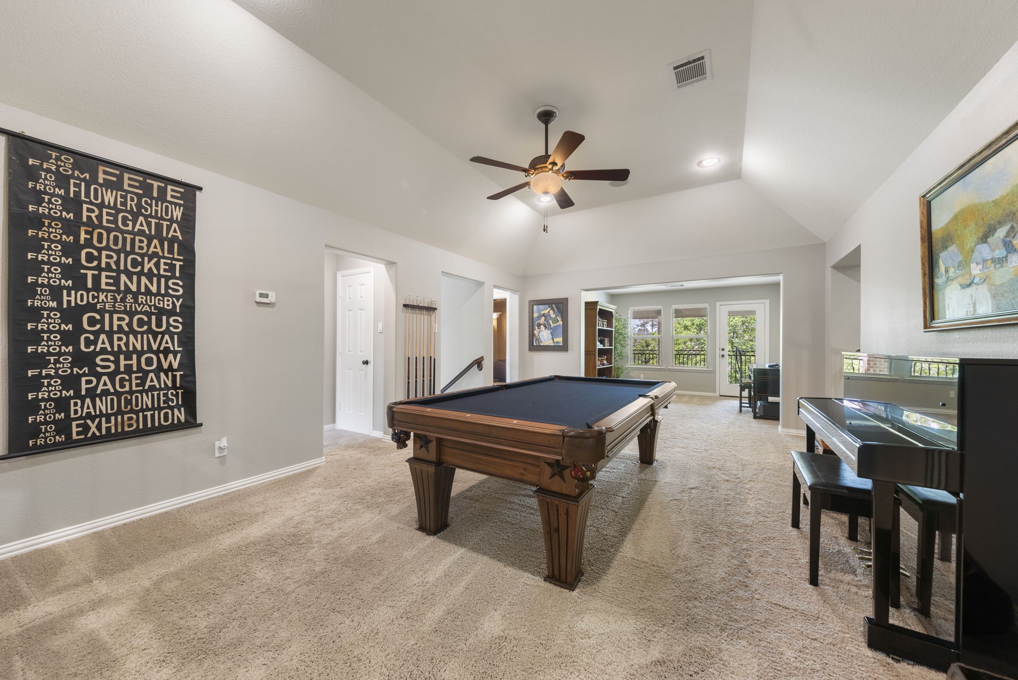 22 Marin Creek Place Spring, TX 77389 - Photo 24 of 38 Inviting game room with a pool table and vaulted ceiling, overlooking the downstairs family room and offering direct access to a large private balcony—perfect for entertaining and taking in the elevated views.