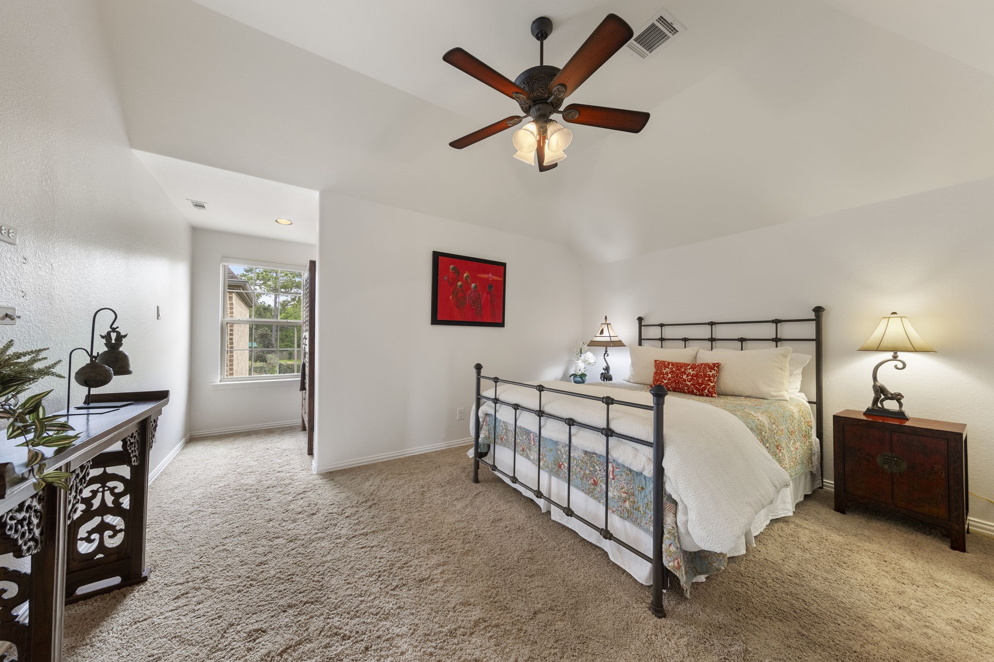 22 Marin Creek Place Spring, TX 77389 - Photo 29 of 38 Generously sized secondary bedroom with vaulted ceilings and soft natural light, offering a comfortable and private retreat.