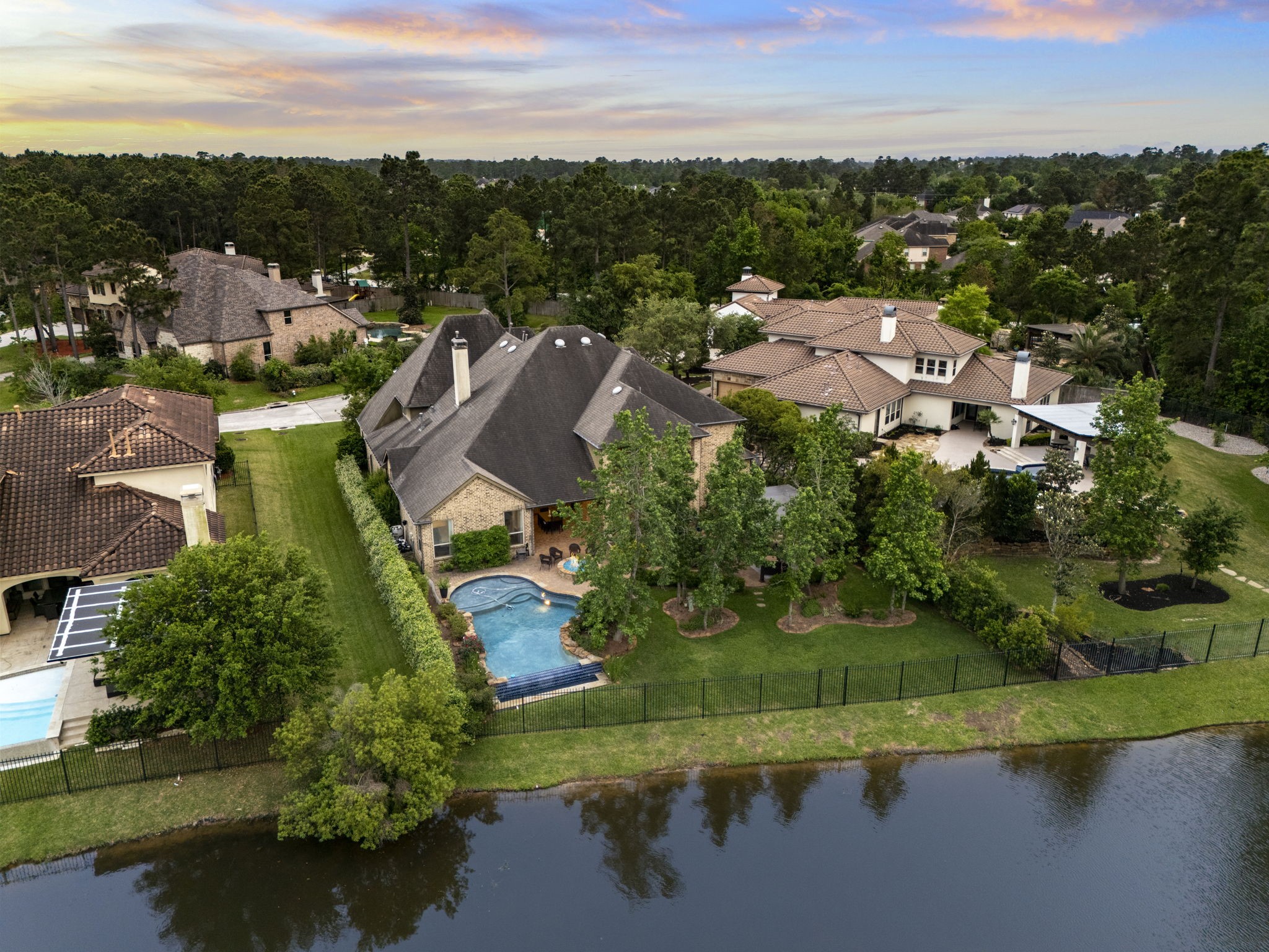 22 Marin Creek Place Spring, TX 77389 - Photo 36 of 38 Aerial view showcasing the home’s prime waterfront setting on Lake Paloma with a private backyard, pool, and mature trees. Beautifully positioned within an established luxury neighborhood.