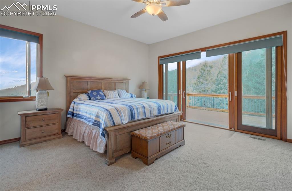 6104 Coffee Pot Road Manitou Springs, CO 80829 - Photo 15 of 49 a spacious bedroom with a bed and large window