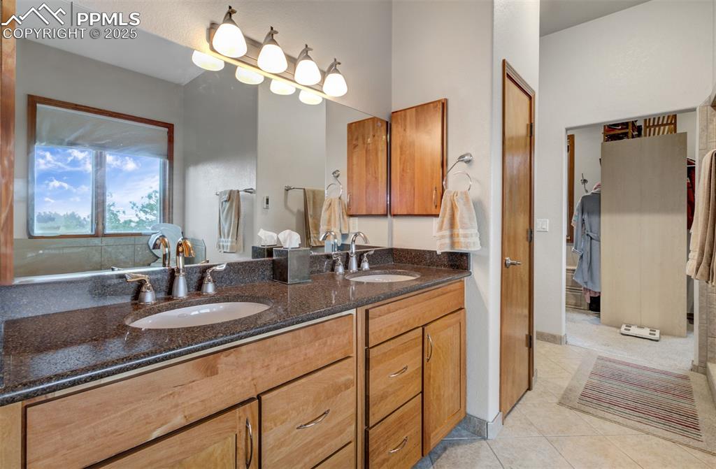 6104 Coffee Pot Road Manitou Springs, CO 80829 - Photo 17 of 49 a bathroom with double vanity and a mirror