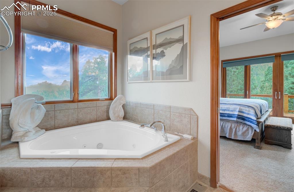 6104 Coffee Pot Road Manitou Springs, CO 80829 - Photo 18 of 49 a bathroom with a tub and large window