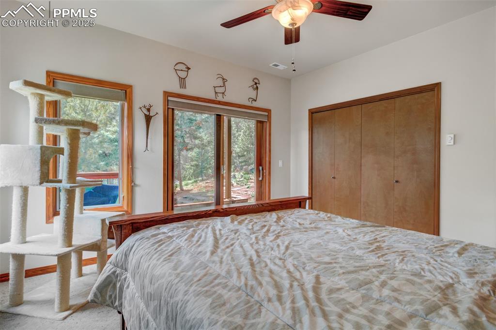 6104 Coffee Pot Road Manitou Springs, CO 80829 - Photo 29 of 49 a bedroom with a large bed and a large window