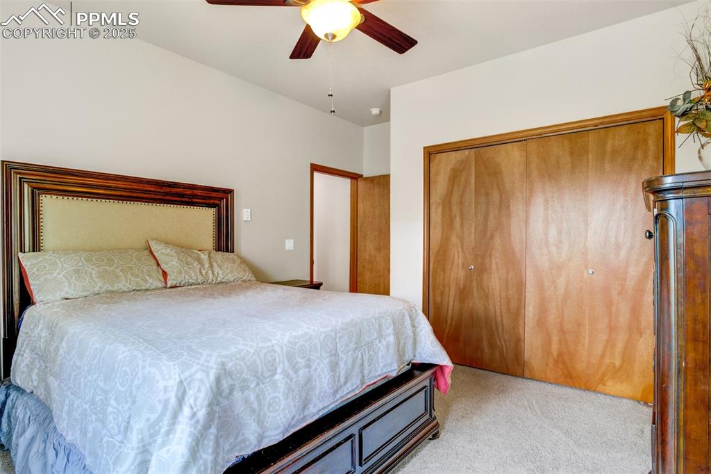 6104 Coffee Pot Road Manitou Springs, CO 80829 - Photo 33 of 49 a bedroom with a bed and a chandelier