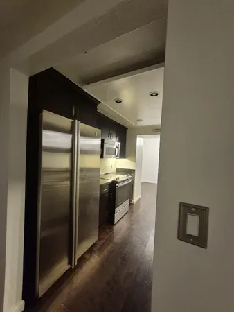 a kitchen with stainless steel appliances a refrigerator and a stove
