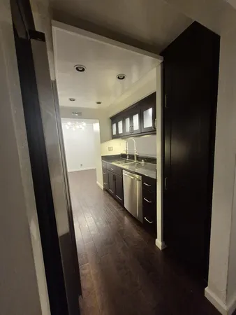 a kitchen with a sink and stainless steel appliances