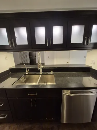 a kitchen with a sink and a mirror