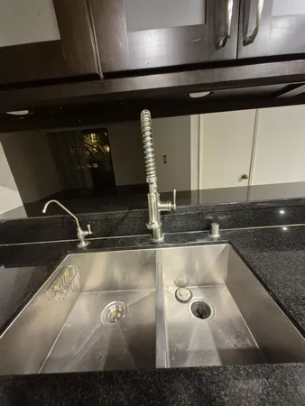 a kitchen with a sink and cabinets