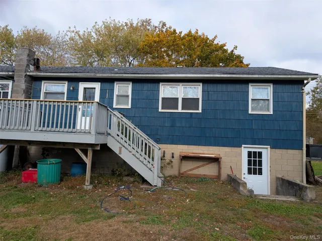 a view of a house with a yard and deck
