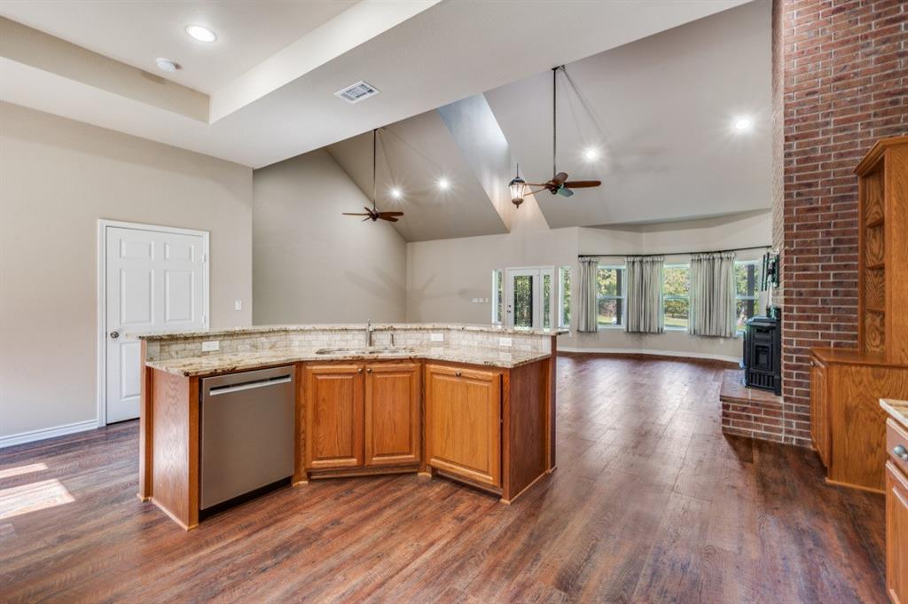 Undisclosed Address Valley View, TX 76272 - Photo 4 of 12 a kitchen with stainless steel appliances granite countertop wooden floors and view living room