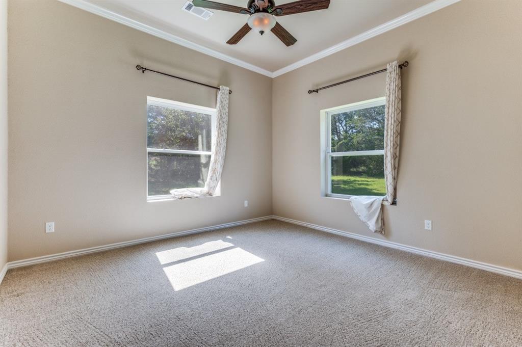 Undisclosed Address Valley View, TX 76272 - Photo 5 of 12 an empty room with a window and ceiling fan