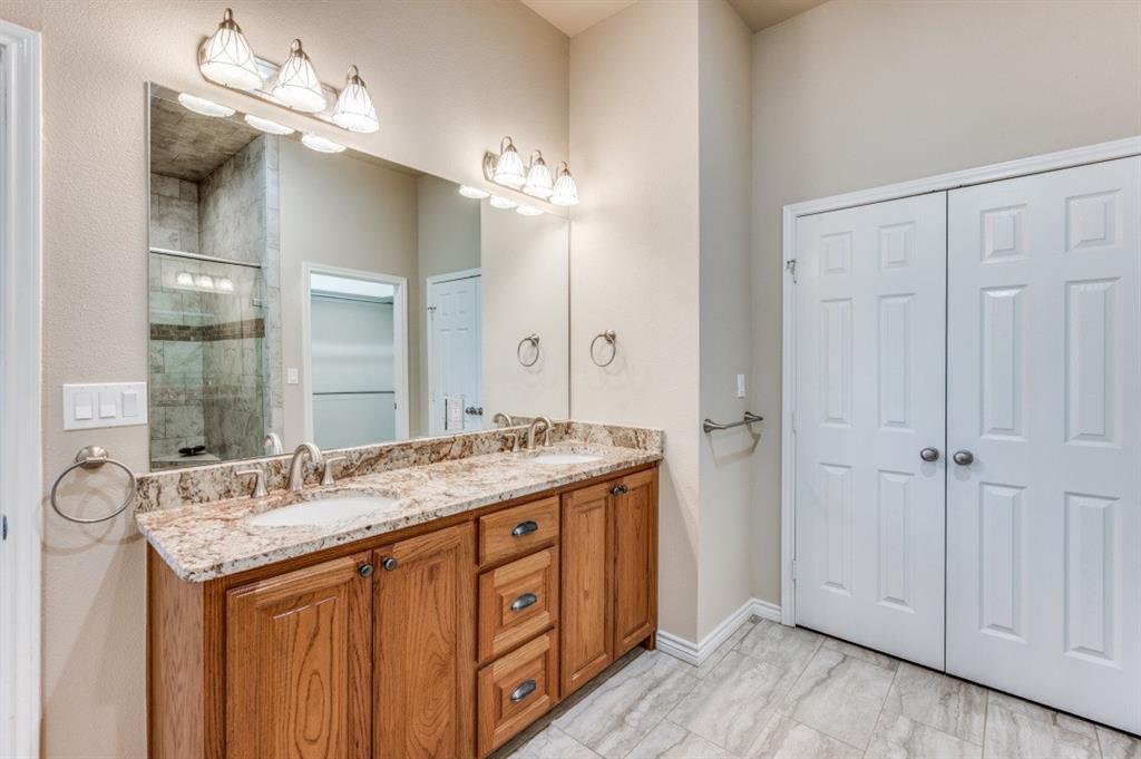 Undisclosed Address Valley View, TX 76272 - Photo 6 of 12 a bathroom with a granite countertop double vanity sink and a mirror
