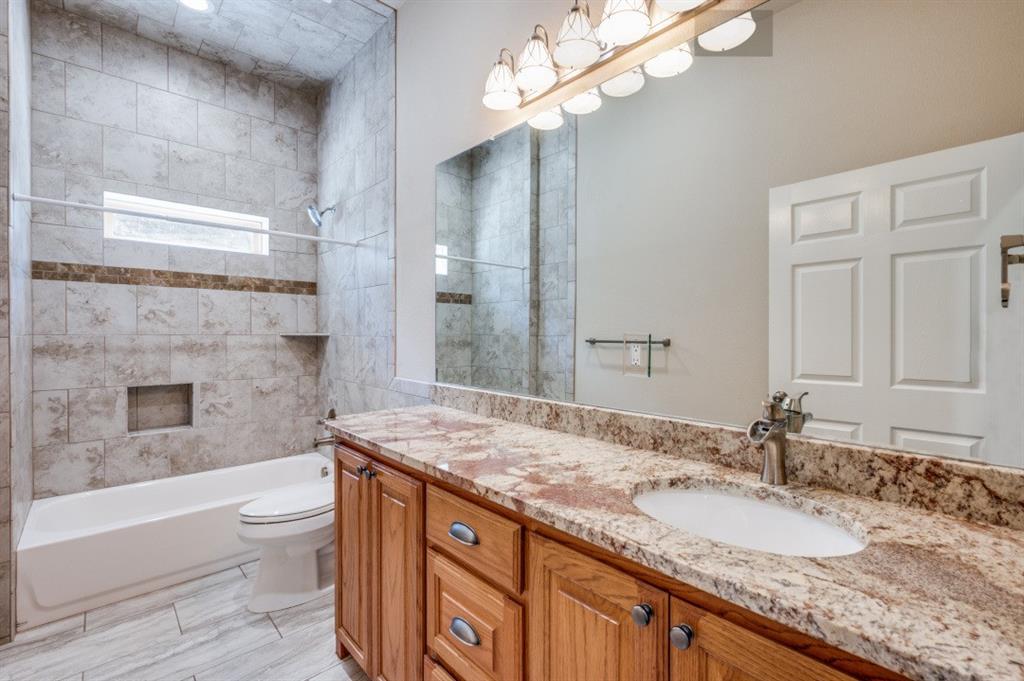 Undisclosed Address Valley View, TX 76272 - Photo 9 of 12 a bathroom with a granite countertop bathtub a sink and a mirror