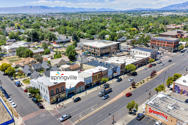 572 South 100 West, Unit E210 Springville, UT 84663 - Photo 34 of 35 Urban landscape featuring commercial buildings, residential structures, and a prominent multi-lane roadway